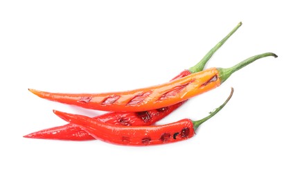 Photo of Tasty grilled chili peppers isolated on white, top view