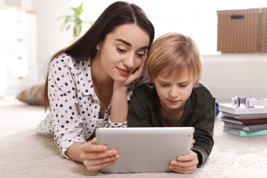 Mother and son reading E-book together at home