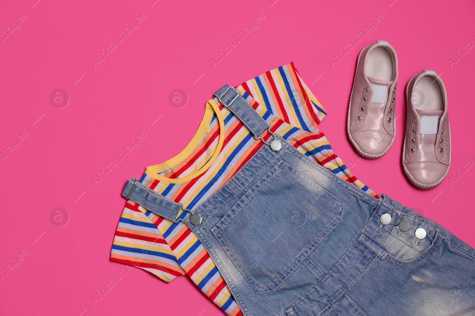 Photo of Child's clothes and shoes on pink background, flat lay