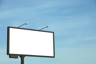 Photo of Blank advertising board in city. Mockup for design