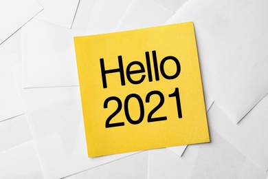 Image of Note with text Hello 2021 on paper sheets, top view