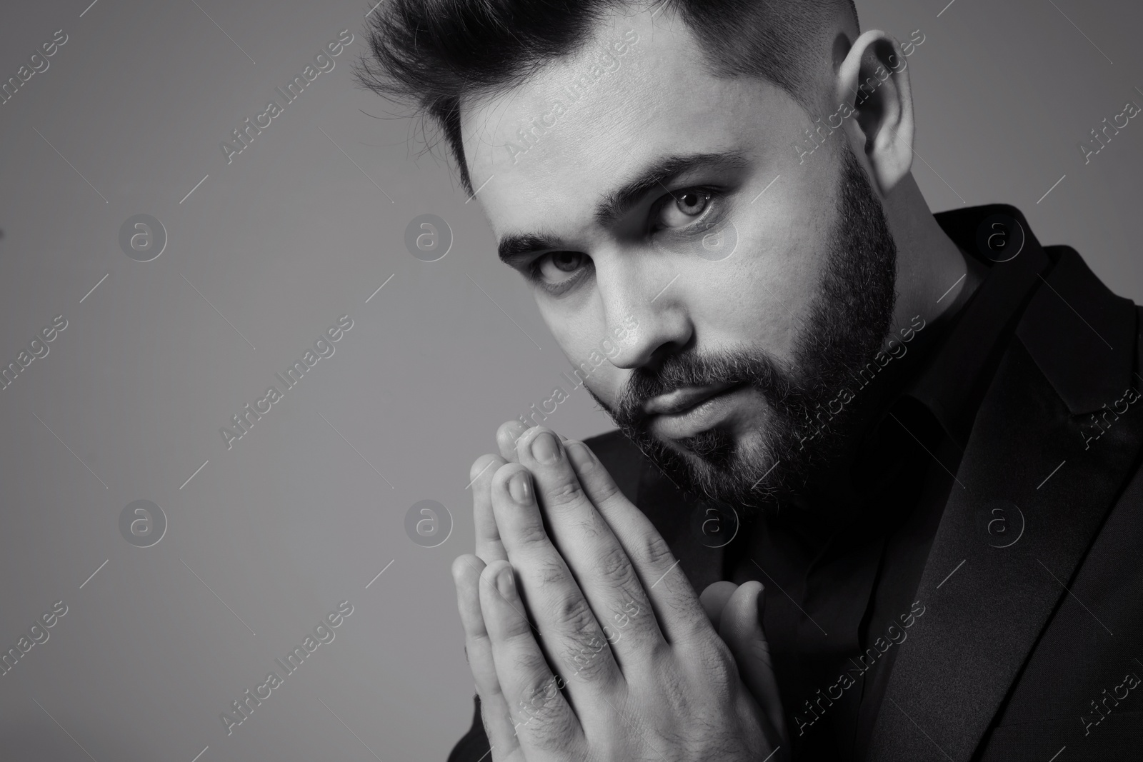 Photo of Handsome bearded man on grey background, space for text. Black and white effect