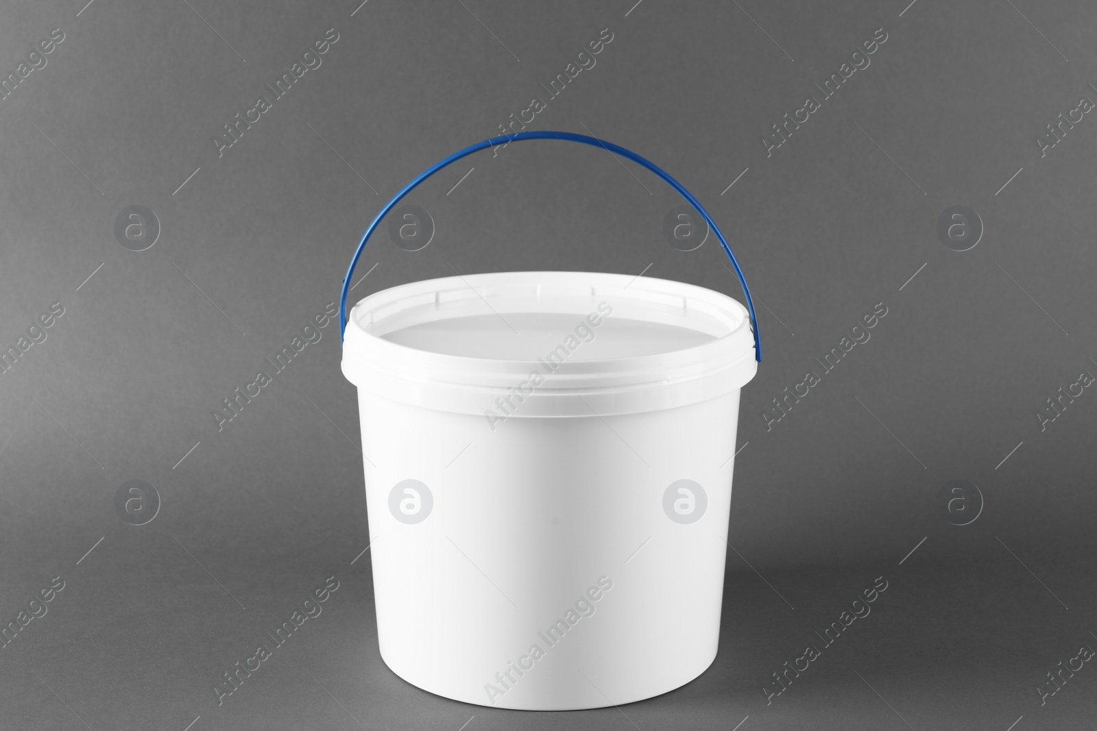 Photo of One plastic bucket with lid on grey background