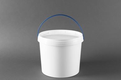 Photo of One plastic bucket with lid on grey background