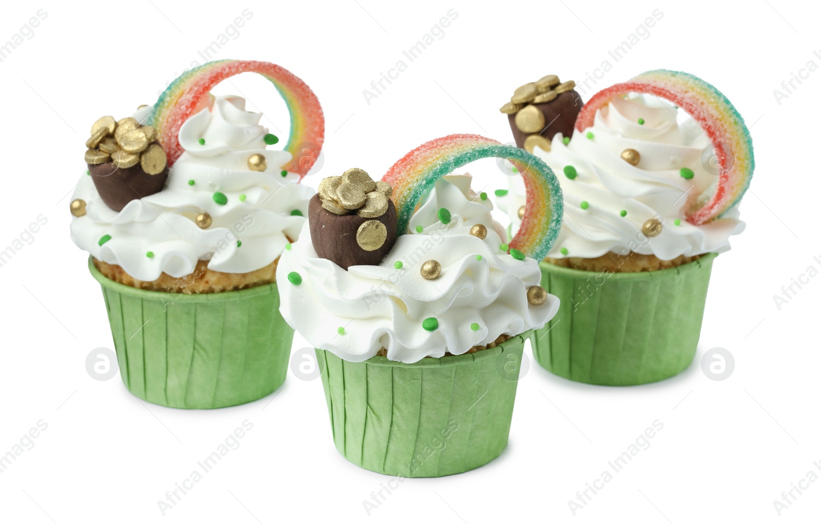 Photo of St. Patrick's day party. Tasty cupcakes with sour rainbow belt and pot of gold toppers isolated on white