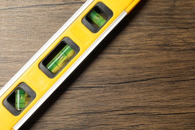 Photo of Building level on wooden table, top view