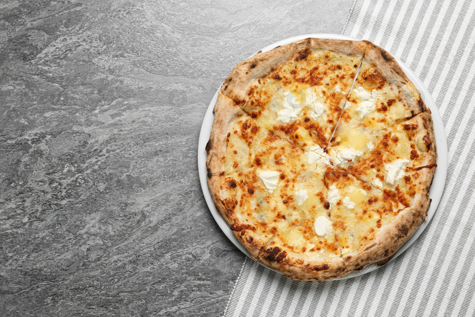 Image of Tasty cheese pizza on grey table, top view. Space for text