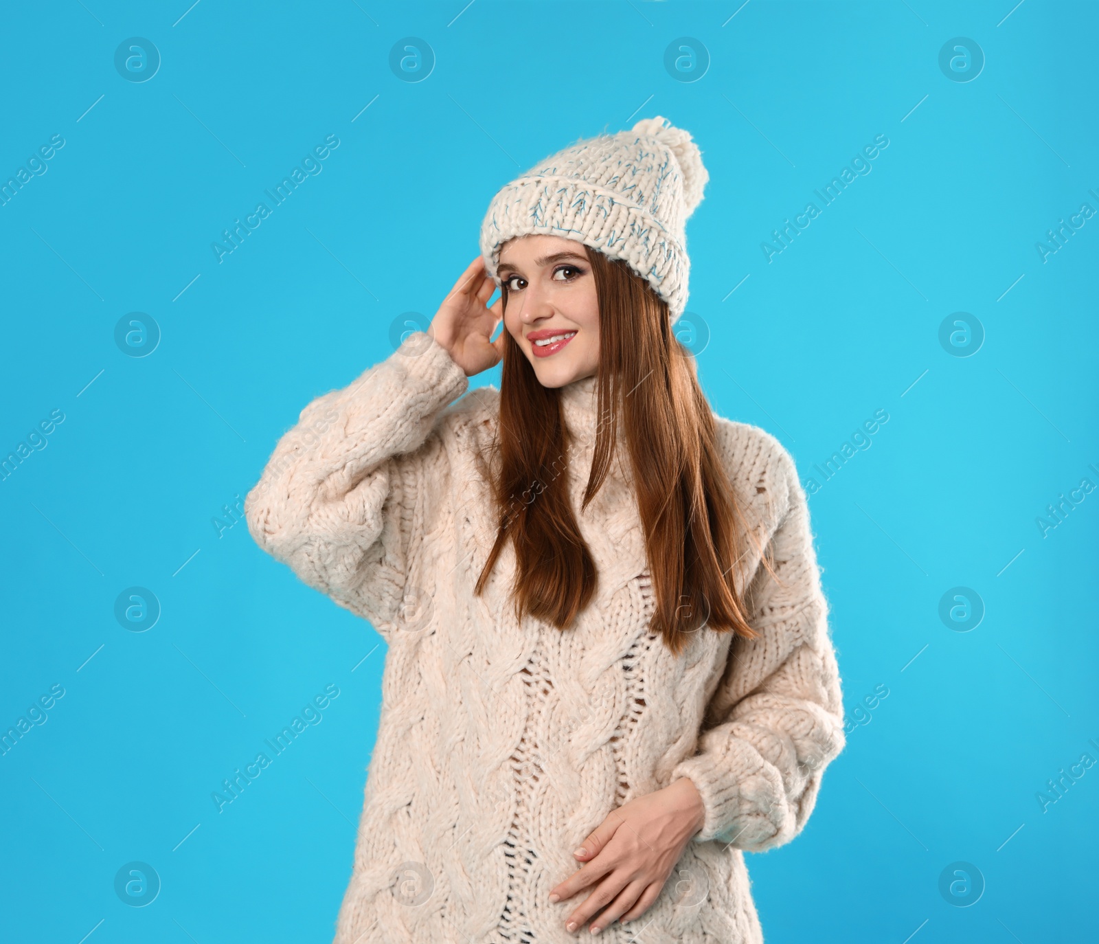 Photo of Young woman wearing Christmas sweater on blue background