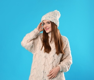 Photo of Young woman wearing Christmas sweater on blue background