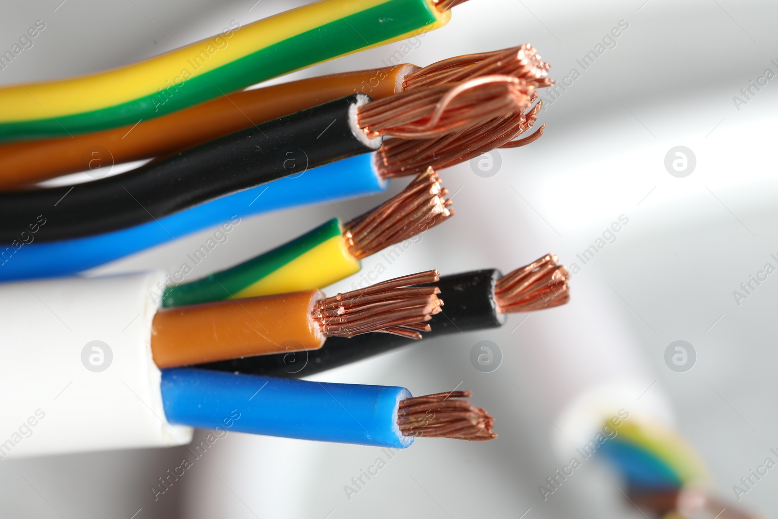 Photo of Colorful electrical wires on blurred background, closeup