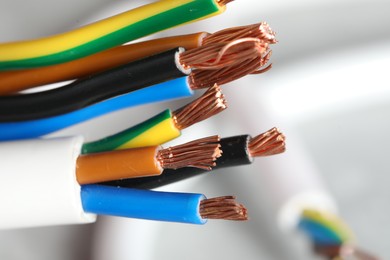 Colorful electrical wires on blurred background, closeup