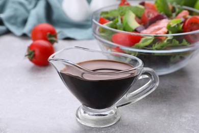 Soy sauce and vegetable salad on grey table, selective focus