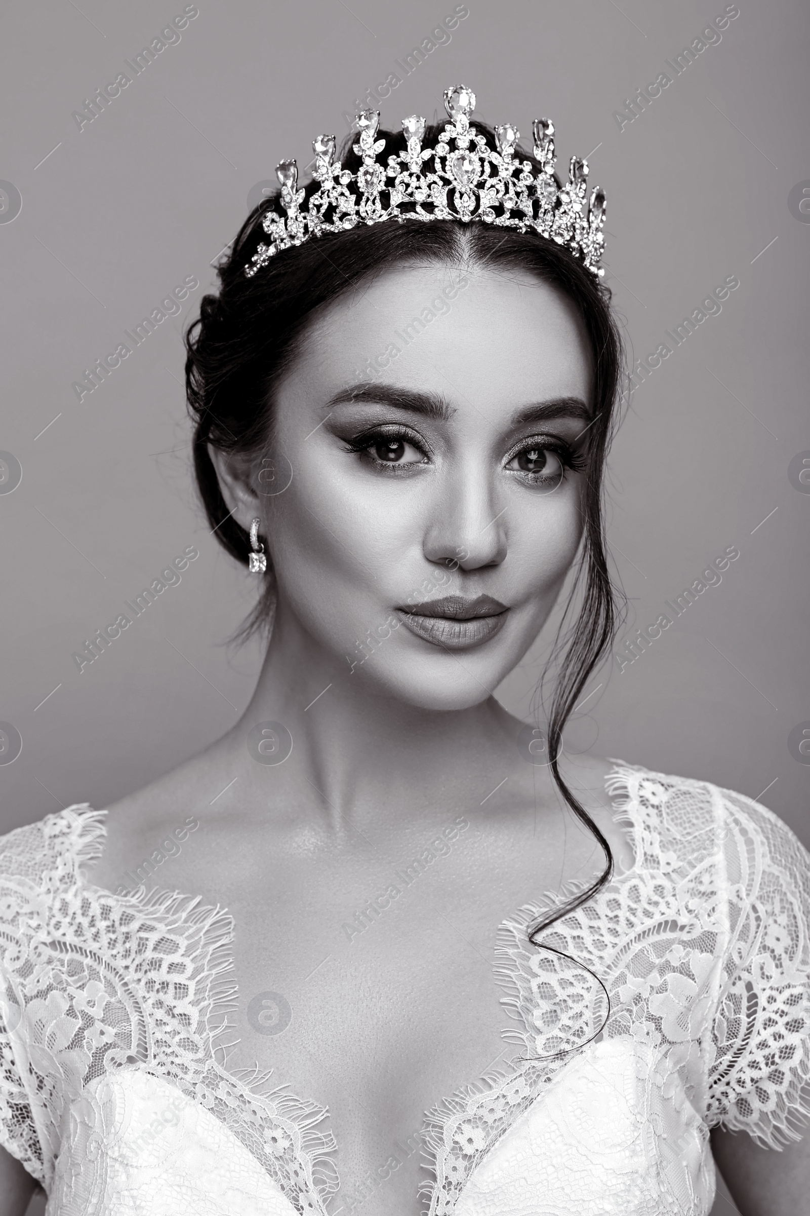 Image of Beautiful young woman wearing luxurious tiara on grey background. Black and white effect