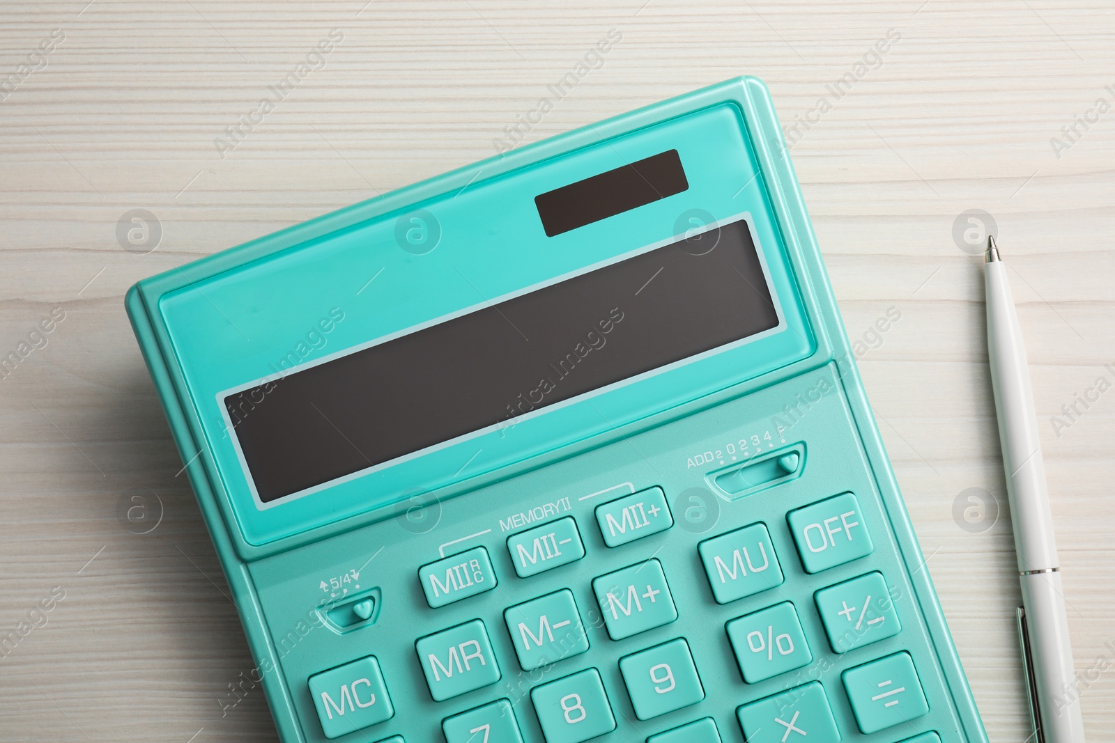 Photo of Calculator and pen on white wooden table, flat lay