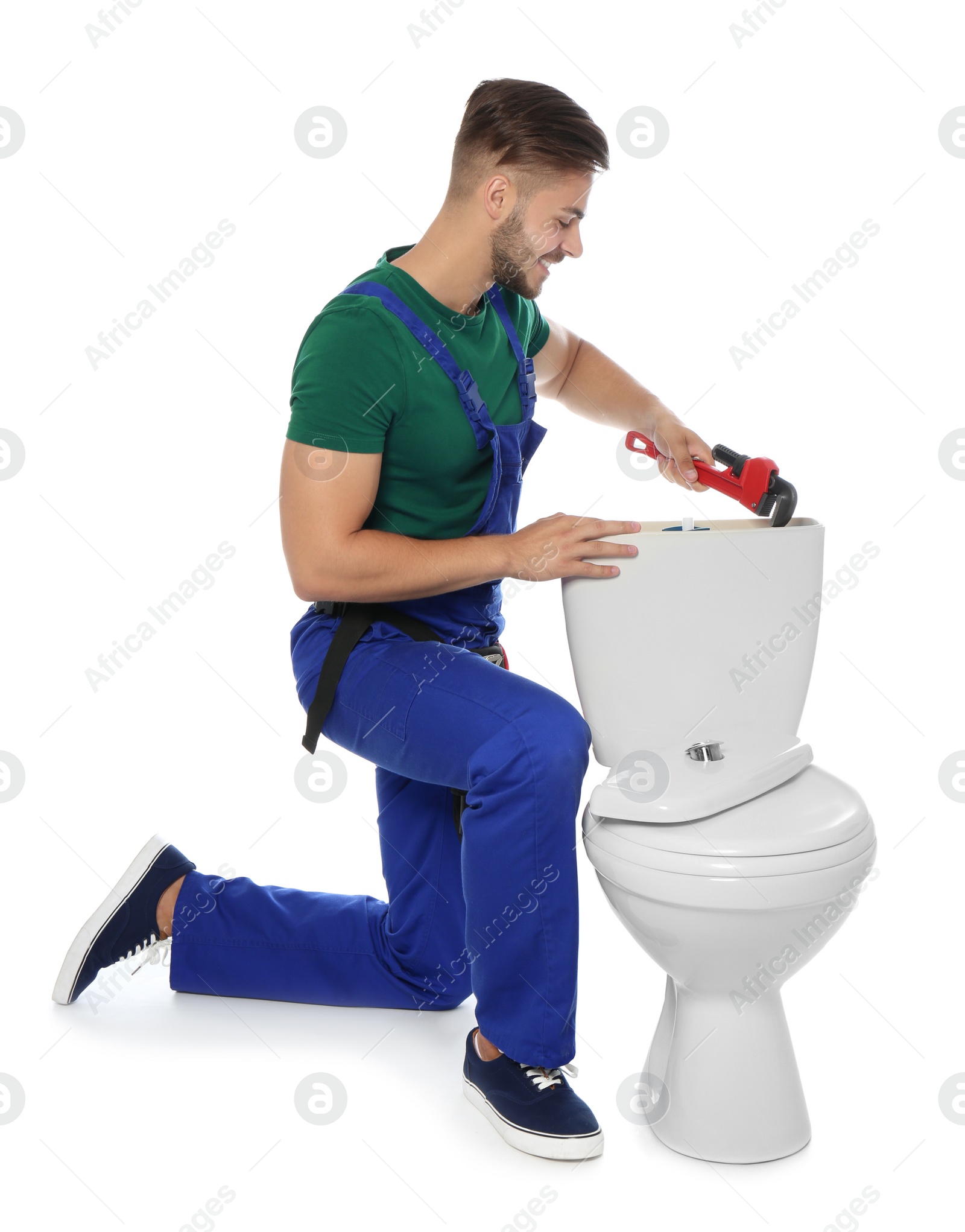 Photo of Young man working with toilet tank, isolated on white