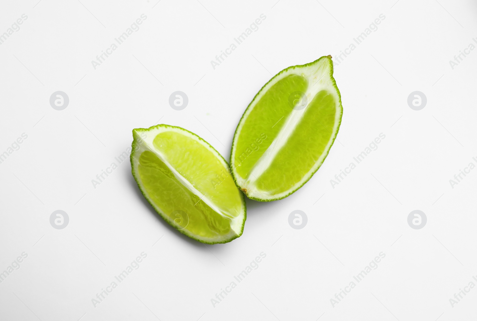 Photo of Cut fresh juicy lime on white background, top view