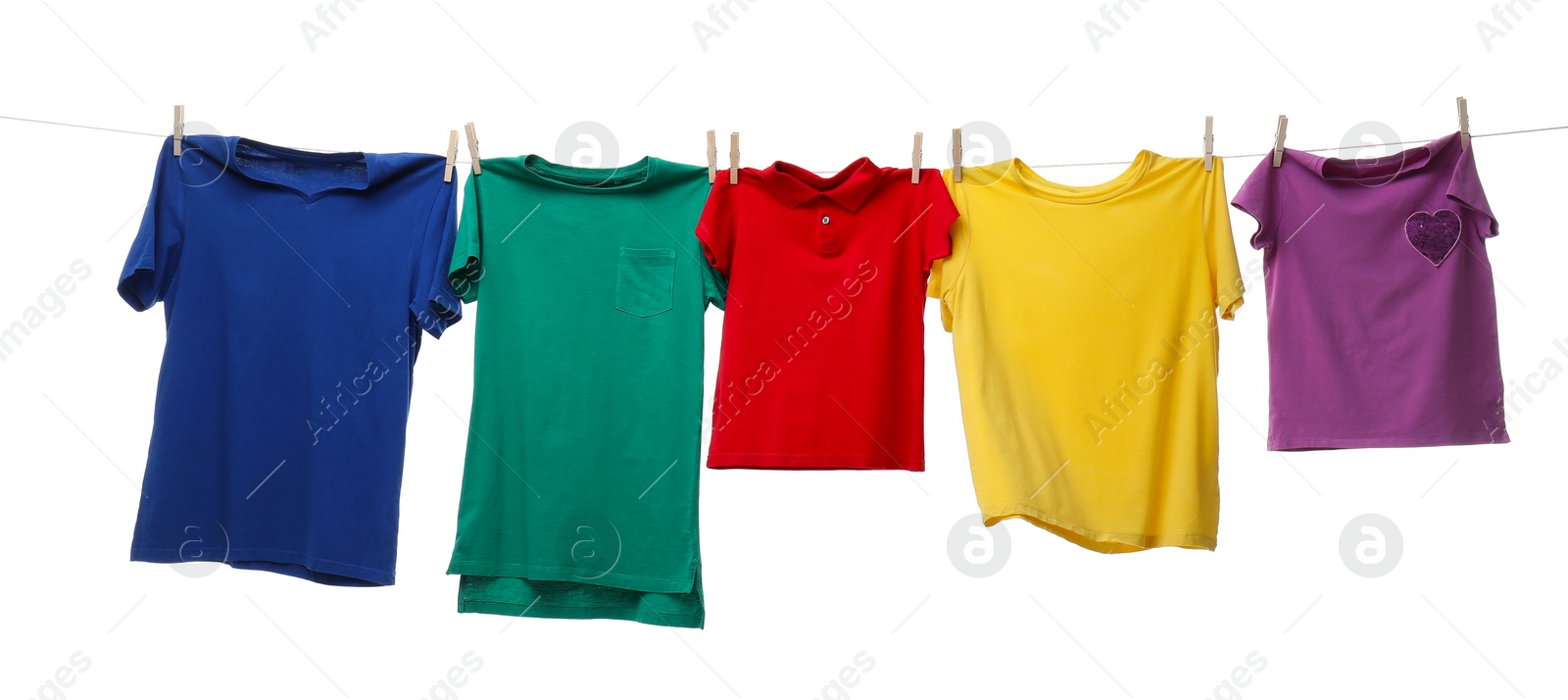 Photo of Colorful t-shirts drying on washing line isolated on white