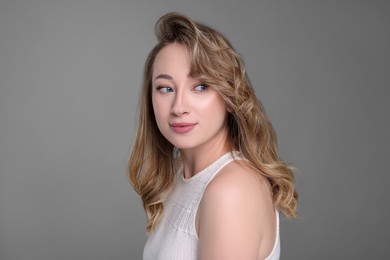 Portrait of beautiful woman on grey background