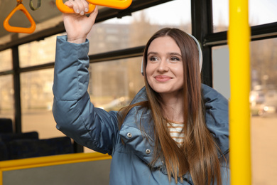 Woman listening to audiobook in trolley bus