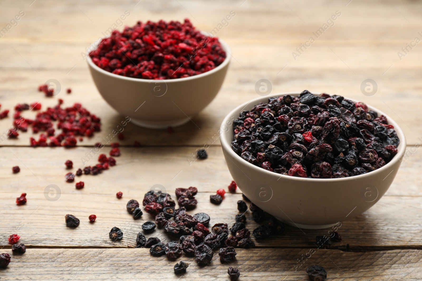 Photo of Dried red and black currant berries on wooden table