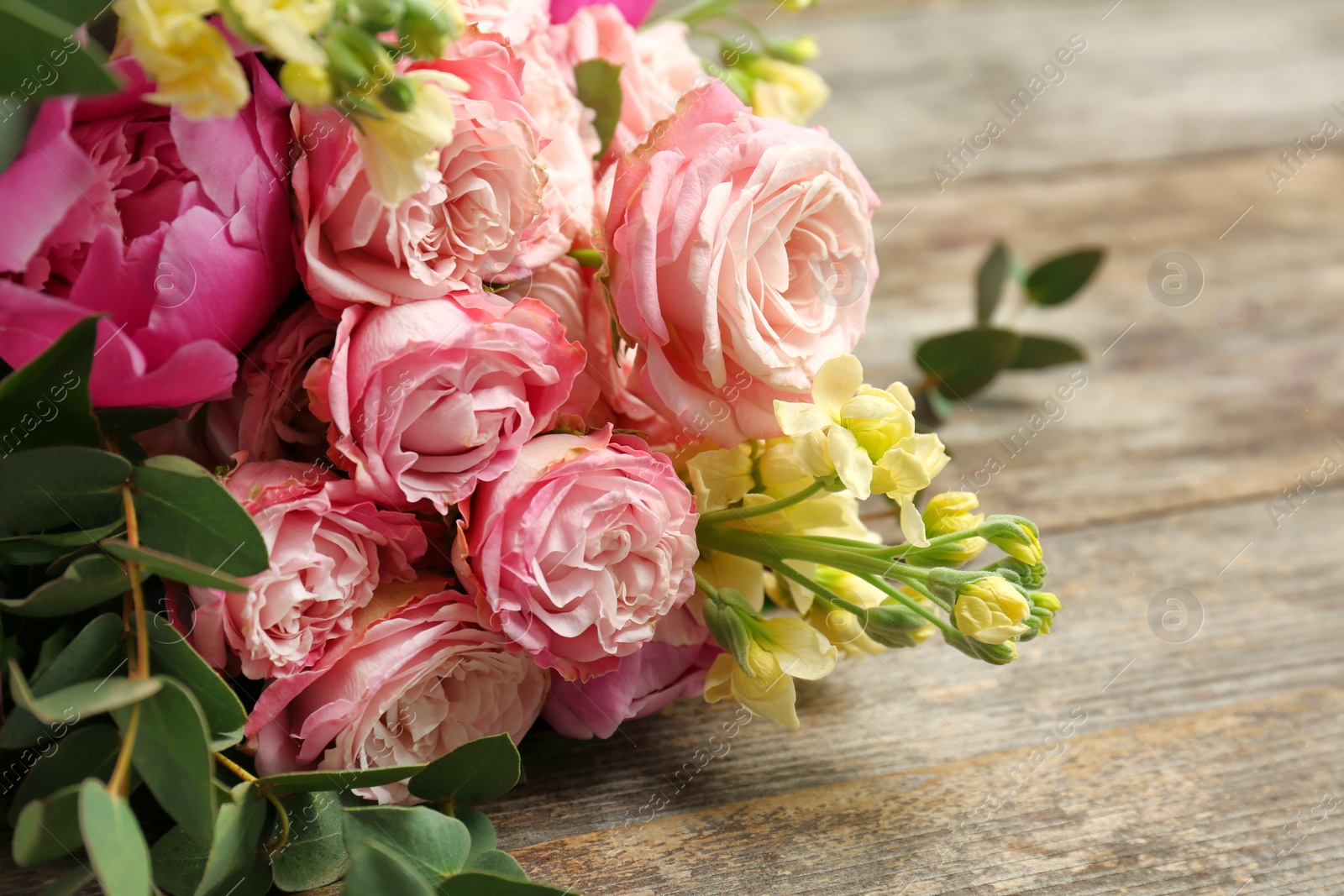 Photo of Bouquet of beautiful fragrant flowers on table, closeup