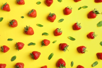 Flat lay composition with with tasty ripe strawberries and mint on color background