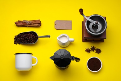 Flat lay composition with vintage manual grinder and geyser coffee maker on yellow background