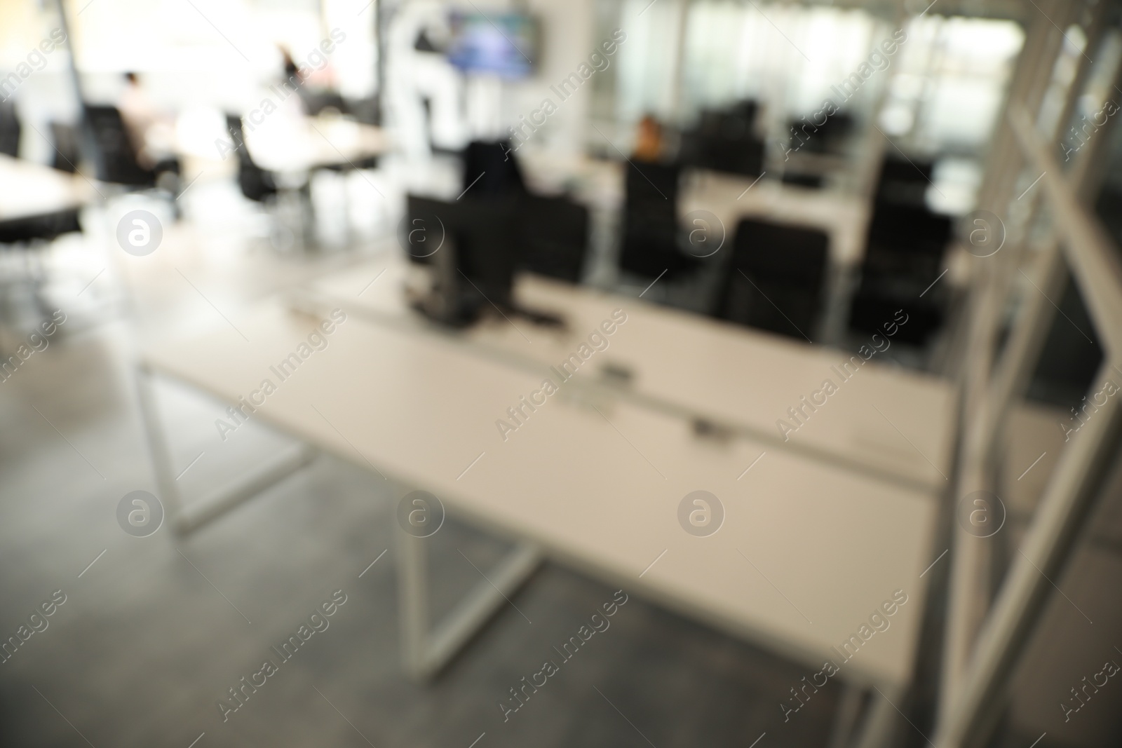 Photo of Blurred view of cozy workspaces with tables and chairs in office