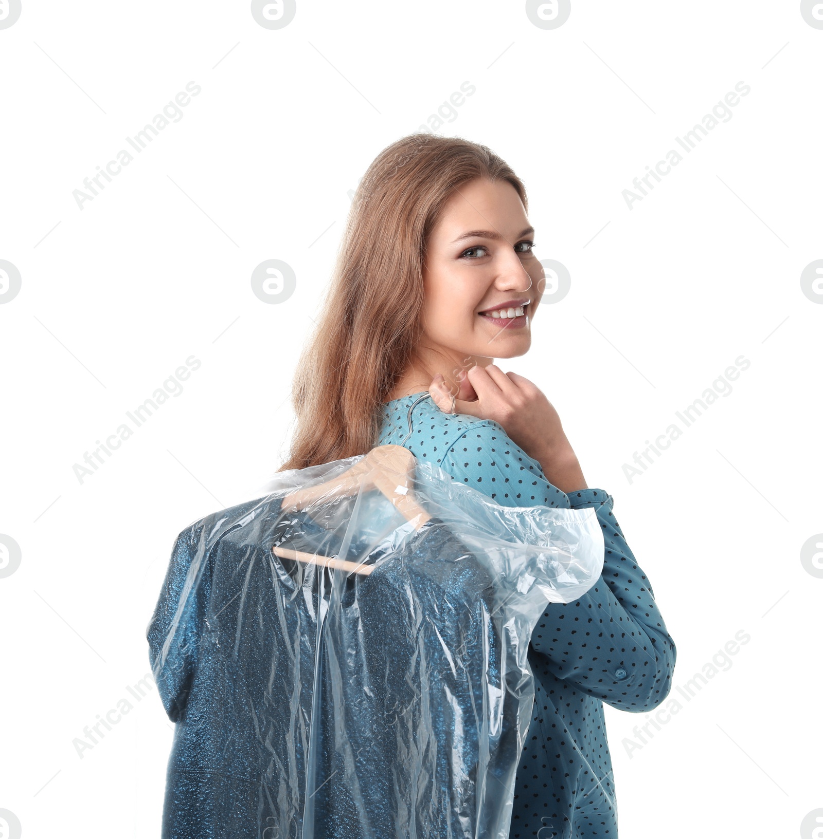 Photo of Young woman holding hanger with dress in plastic bag on white background. Dry-cleaning service