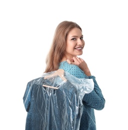 Young woman holding hanger with dress in plastic bag on white background. Dry-cleaning service