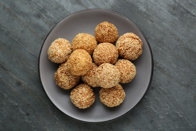 Photo of Delicious sesame balls on grey table, top view