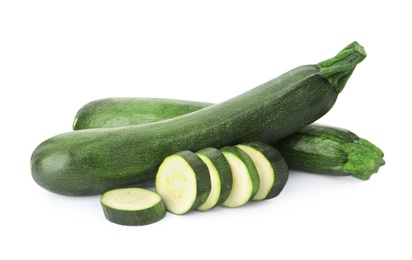 Cut and whole green ripe zucchini isolated on white