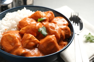 Photo of Delicious butter chicken with rice served on table
