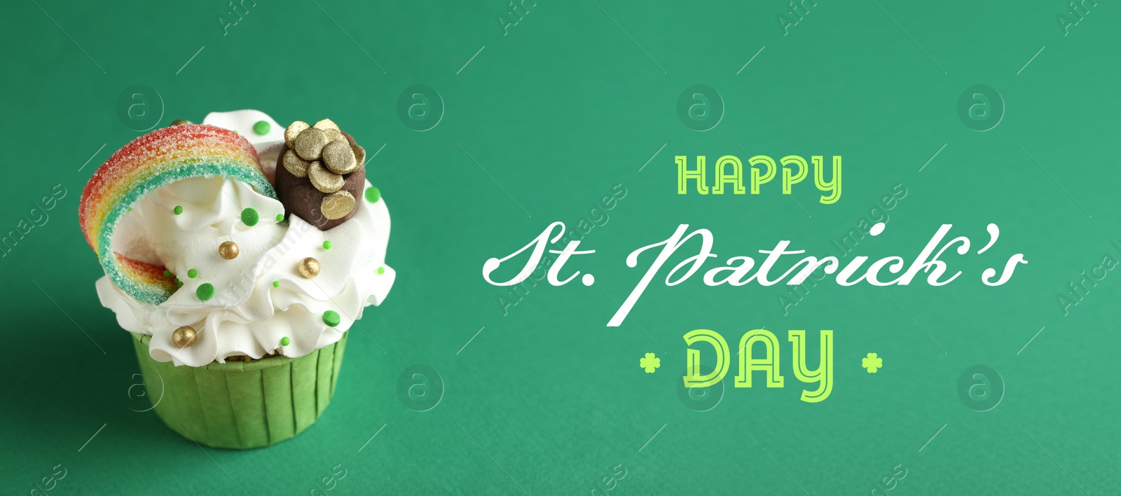 Image of Happy St. Patrick's day card. Tasty cupcake with sour rainbow belt and pot of gold toppers on green background. Banner design