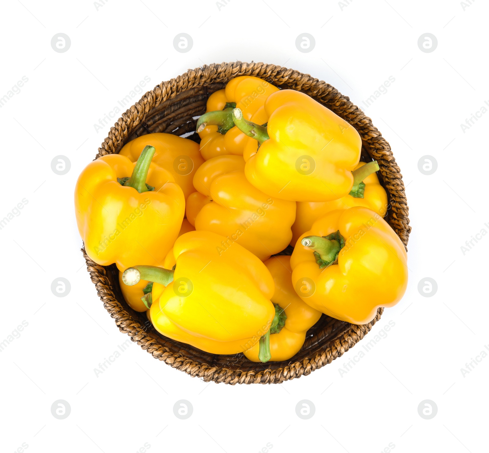 Photo of Wicker bowl of ripe yellow bell peppers isolated on white, top view