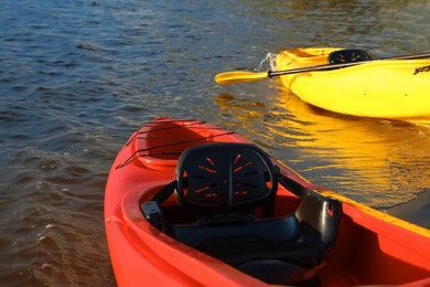 Beautiful modern kayaks on beach near river