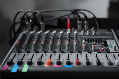 Photo of Modern audio mixing console, closeup. Music equipment