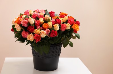 Photo of Bouquet of beautiful roses on table indoors. Space for text