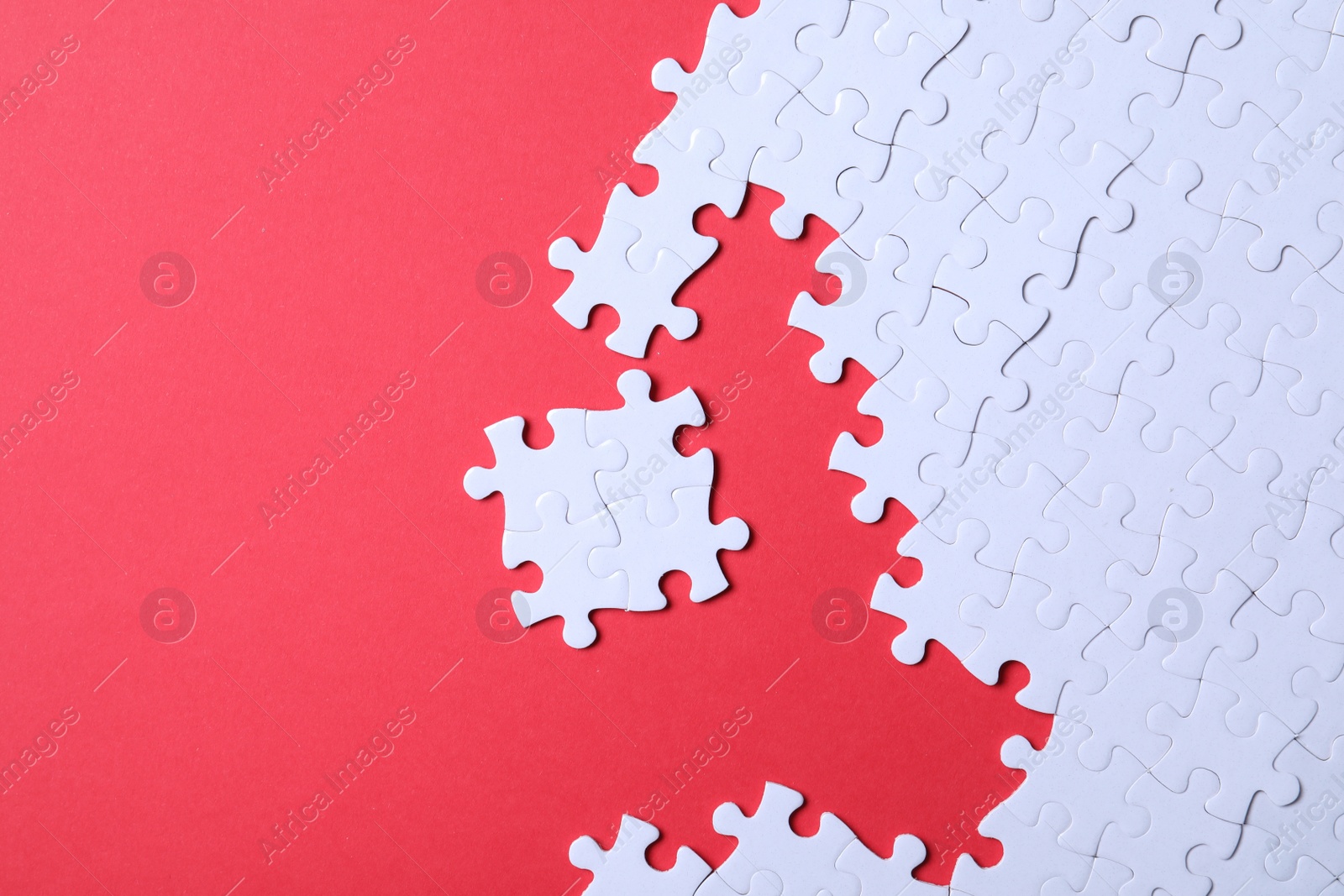 Photo of Blank white puzzle pieces on red background, flat lay