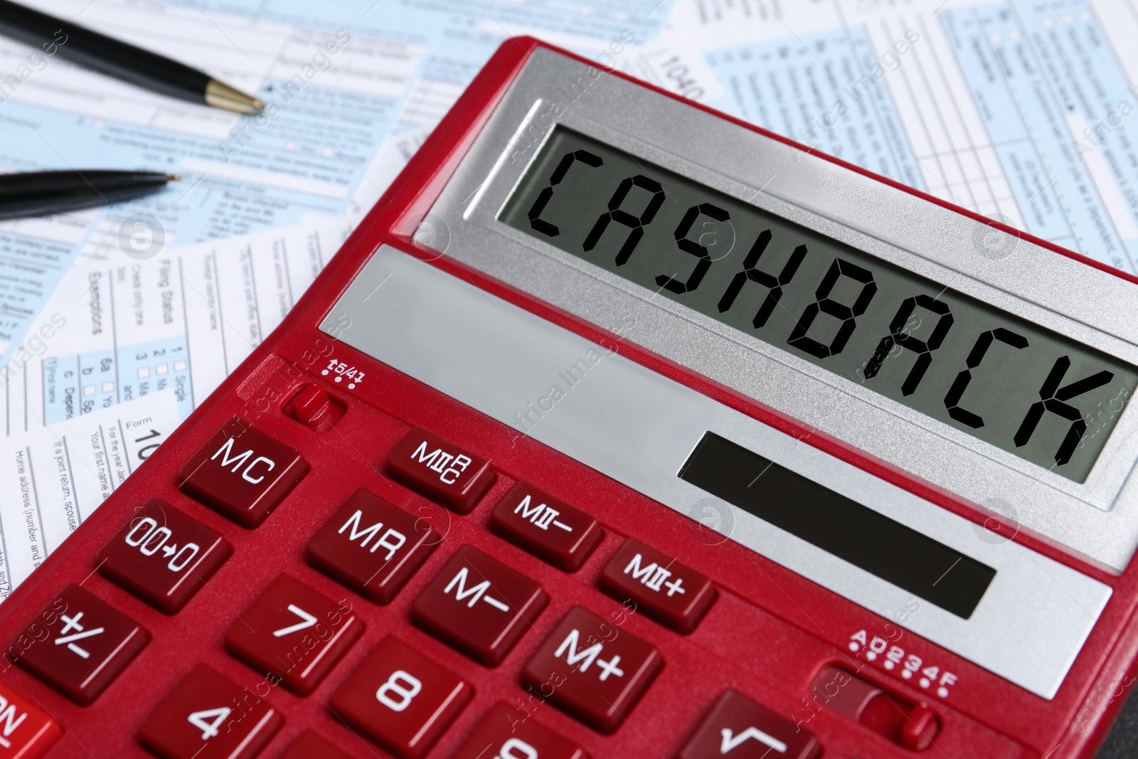 Image of Calculator with word Cashback on documents, closeup