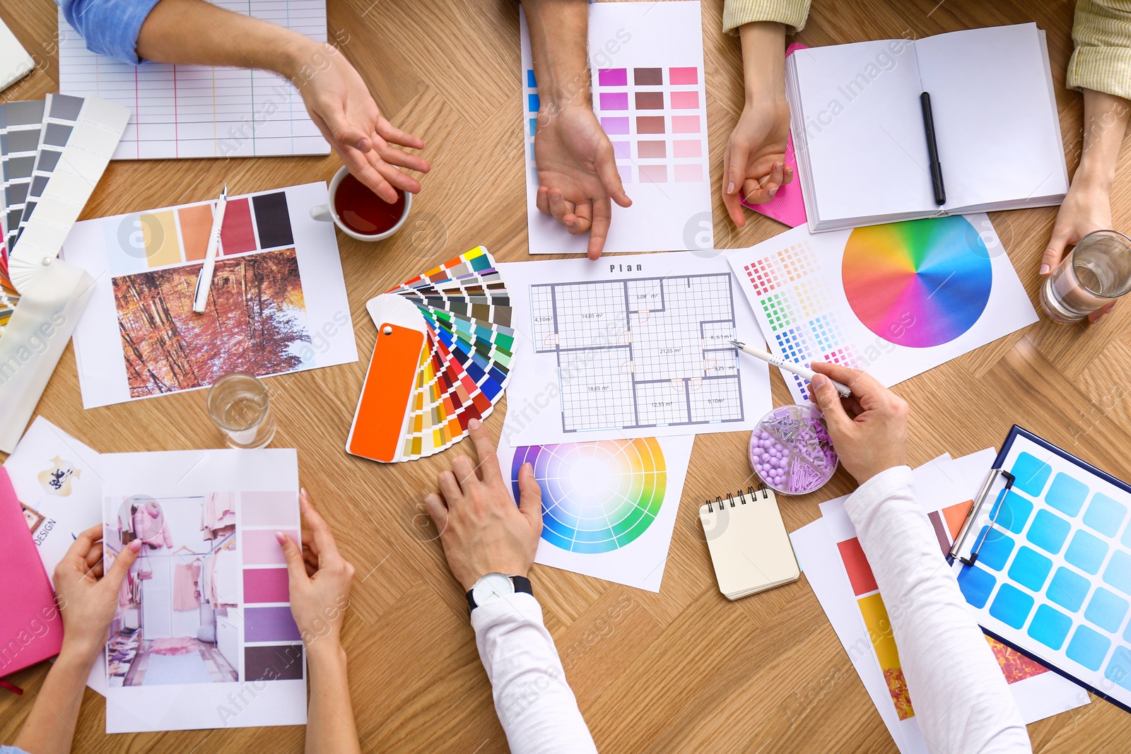 Photo of Professional team of interior designers working at table, top view