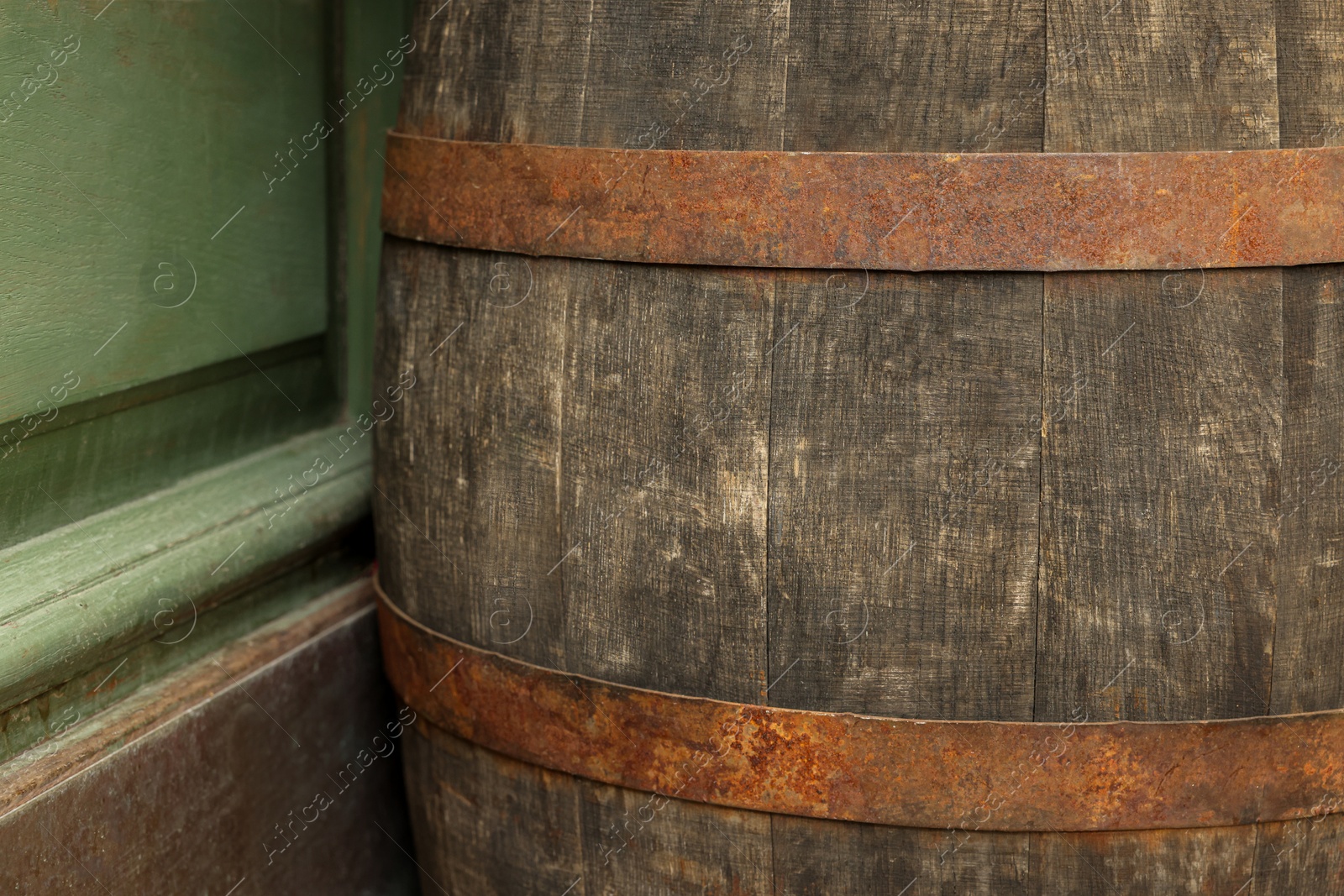 Photo of Traditional wooden barrel outdoors, closeup. Wine making