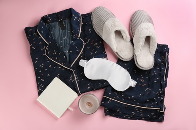 Photo of Composition with house slippers, sleeping mask and pajamas on pink background, flat lay