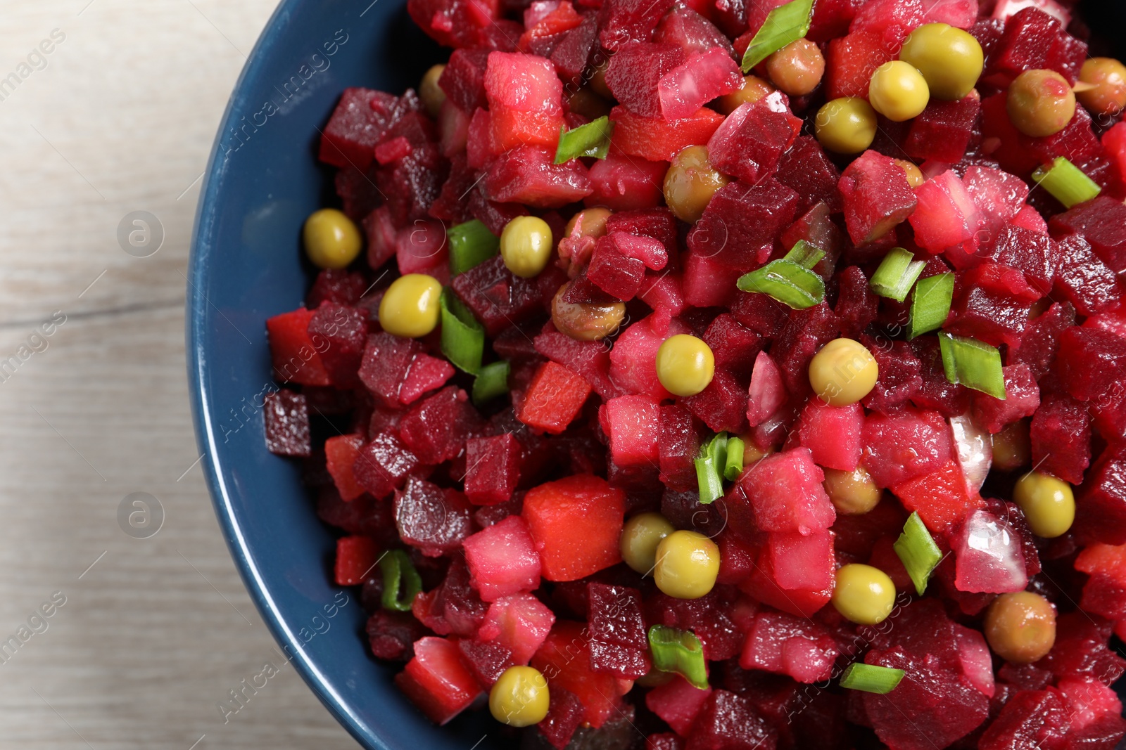 Photo of Delicious fresh vinaigrette salad on white table, closeup