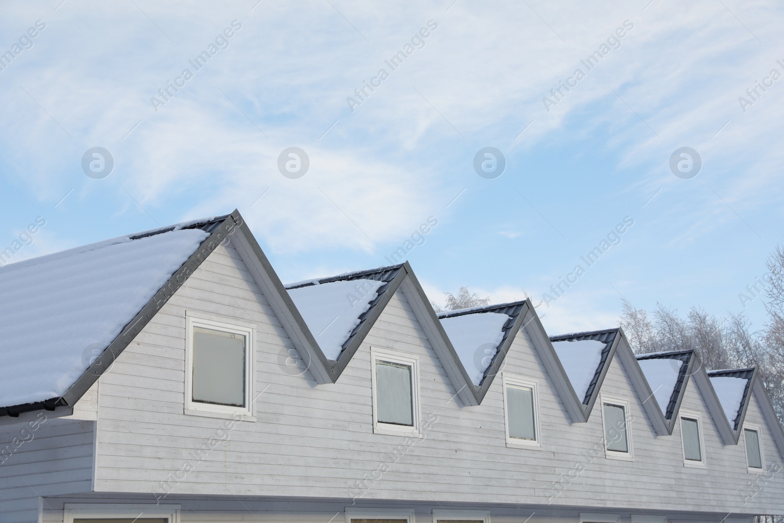 Photo of House roofs covered with snow under cloudy sky