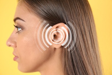 Image of Hearing loss concept. Woman and sound waves illustration on yellow background, closeup