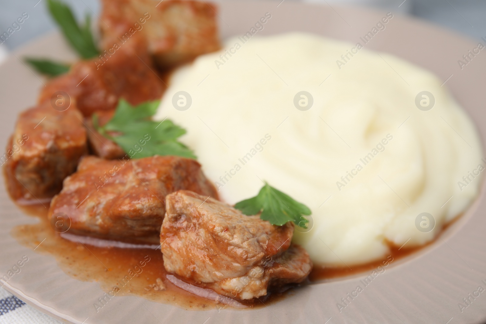 Photo of Delicious goulash and mashed potato on plate, closeup