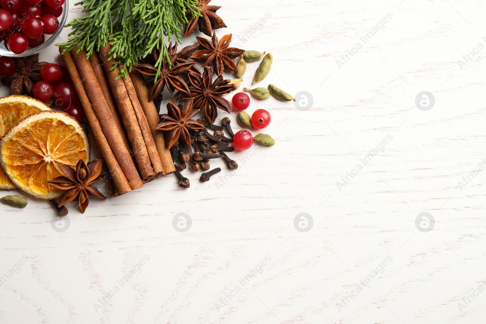 Photo of Flat lay composition with mulled wine ingredients on white table. Space for text