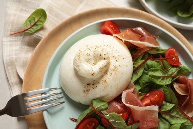 Photo of Delicious burrata salad served on table, top view