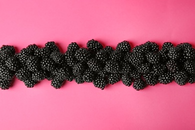 Photo of Flat lay composition with ripe blackberries on pink background